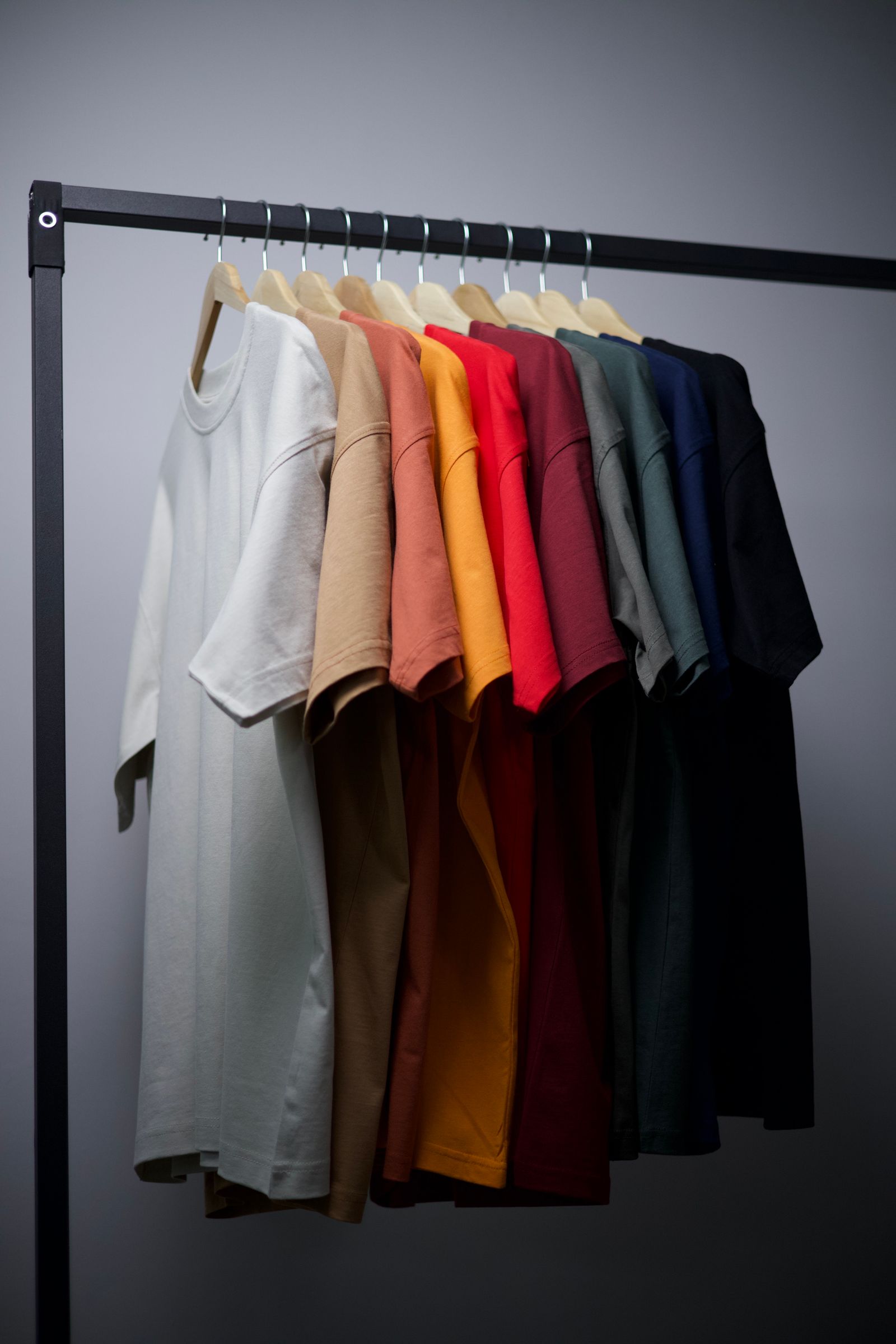 Blank tees in many colors on a rack
